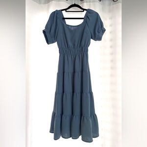 Junior small dark blue dress, goes to knee area. Cute and casual.